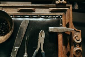 Top view of vintage tools on a wooden table, perfect for restoration and craft themes.